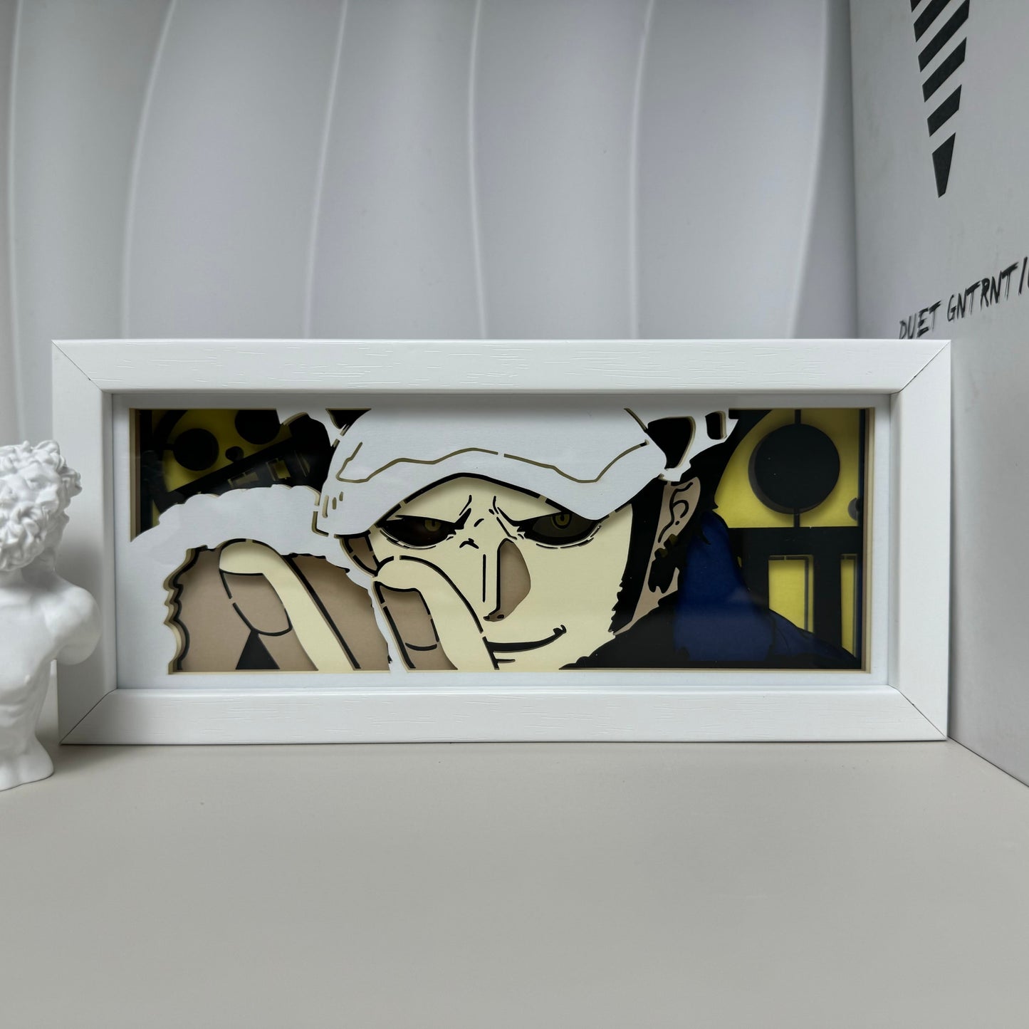 One Piece Trafalgar D. Water Law anime light box by MyAnimeLightbox, display off, in white frame with decorative background