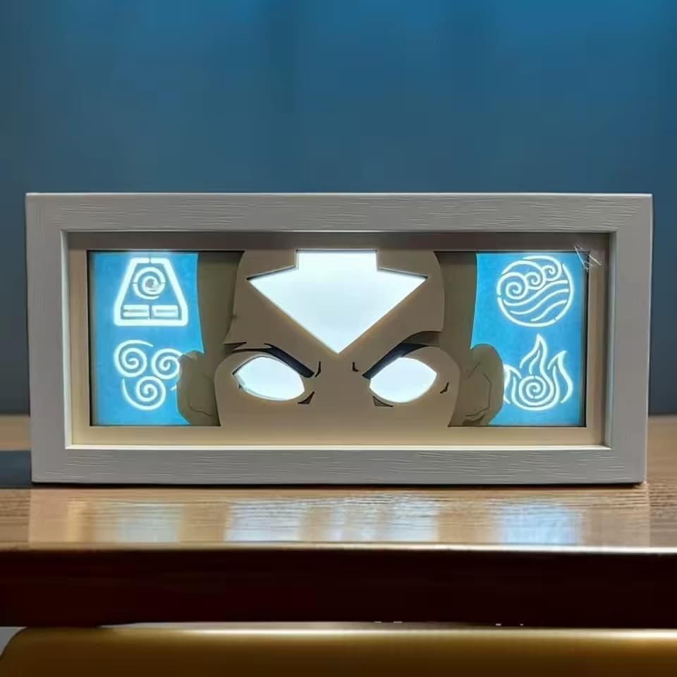 Vue avant de la boîte lumineuse à état Aang Avatar avec symboles élémentaires bleus brillants