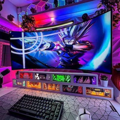 Gaming setup with a large monitor displaying a character, keyboard, and mouse on a desk.