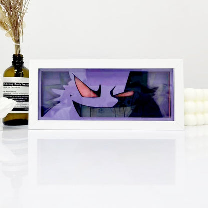 Kotak cahaya anime gerbang malam pokemon gongar oleh myanimelightbox, dipaparkan, dalam bingkai putih dengan latar belakang hiasan
