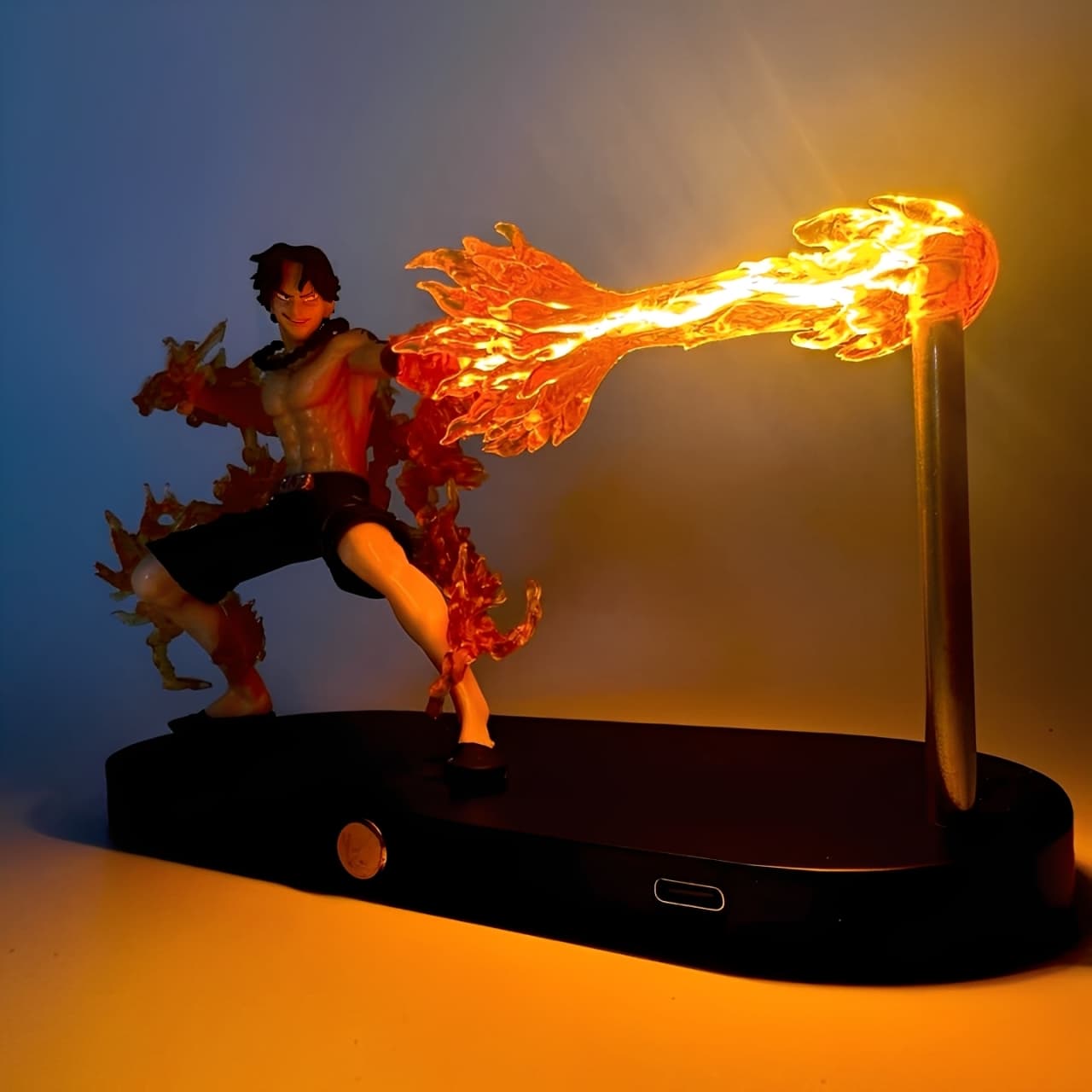 Anime figure of Ace releasing a fire blast with LED lighting on a display stand.