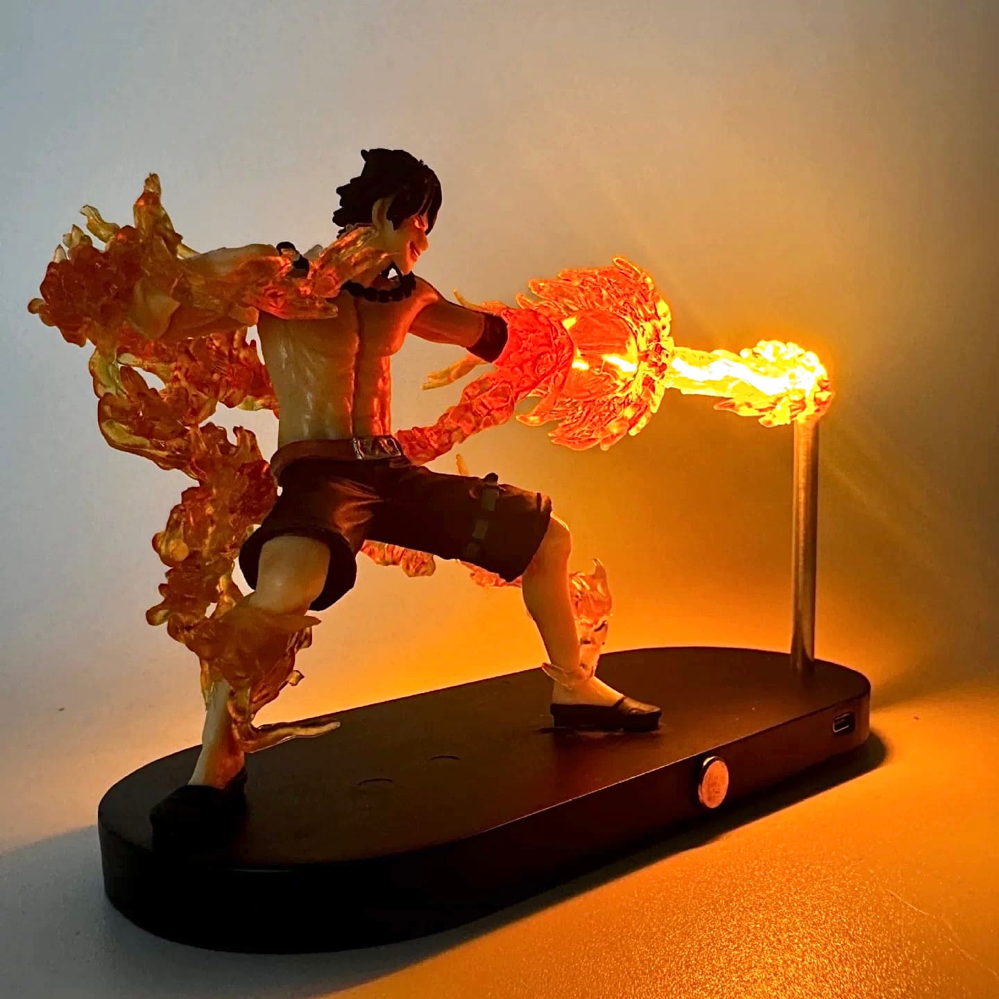 Back angle shot of Ace figure with swirling fire effects and LED flame lighting.
