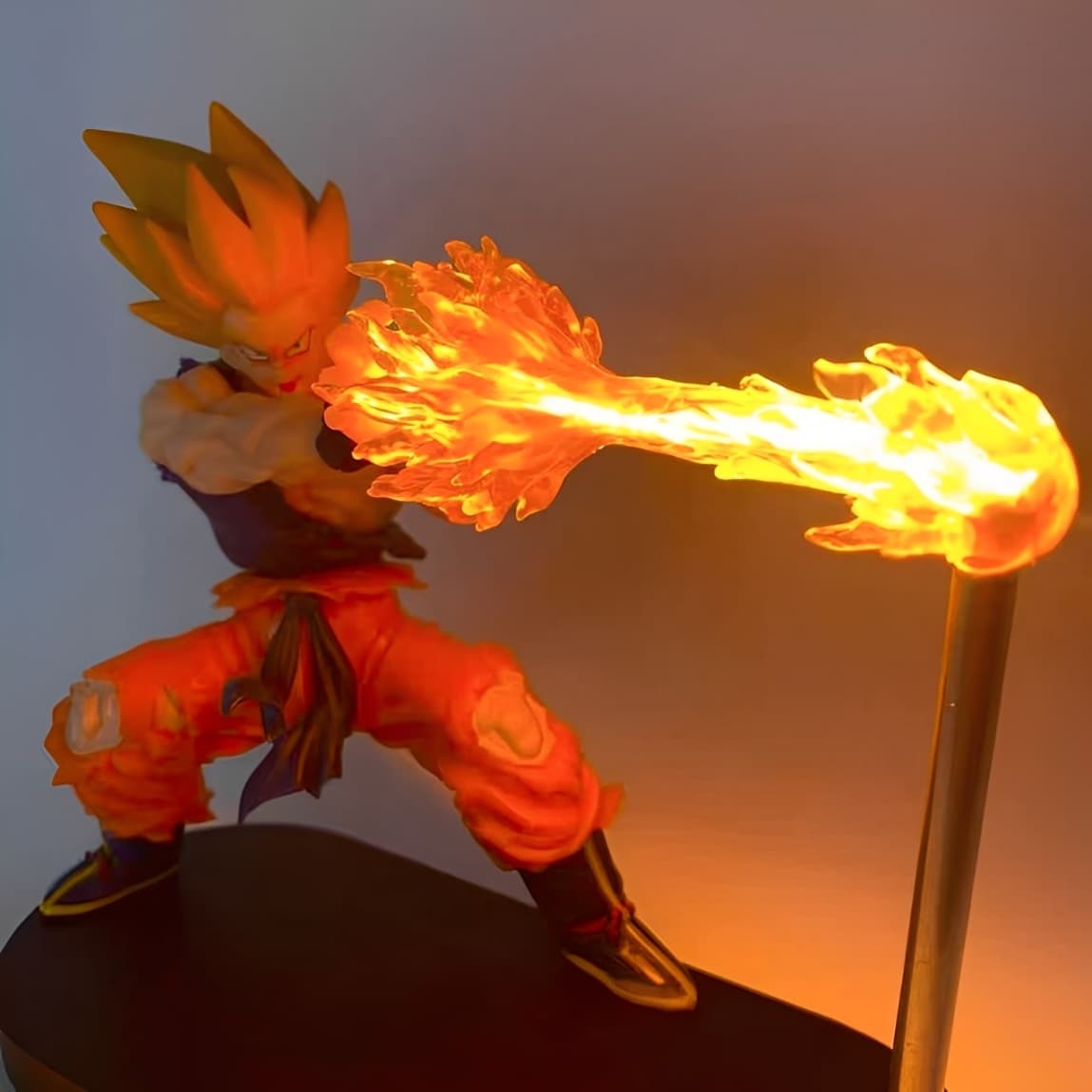 Dynamic angle of Super Saiyan Goku figure with illuminated fire blast effect.