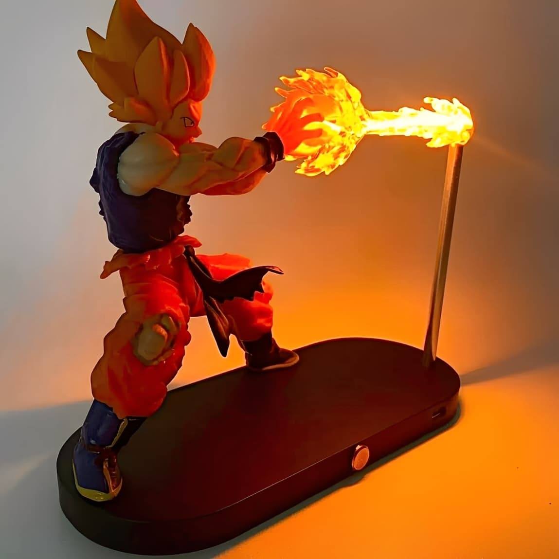 Back view of Goku figure performing a fiery LED energy attack.
