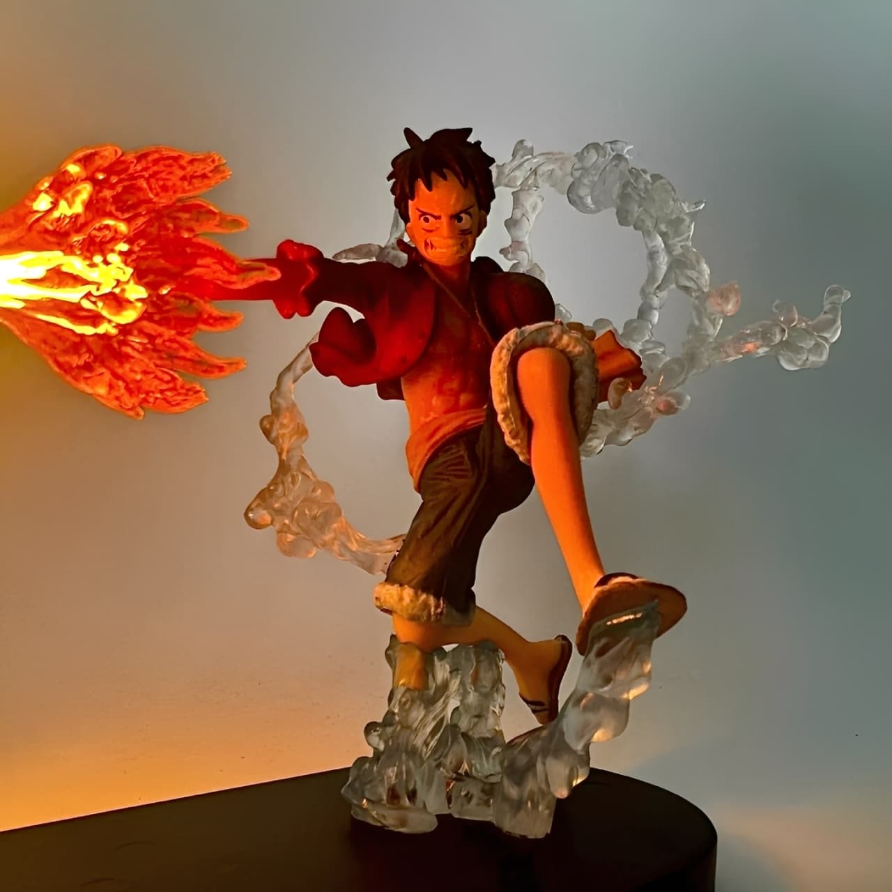 Close-up of Luffy Fire Fist LED action figure with illuminated flame effect
