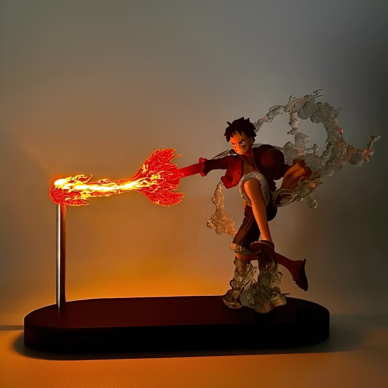 Luffy LED flame punch figure on display base with glowing fire effect
