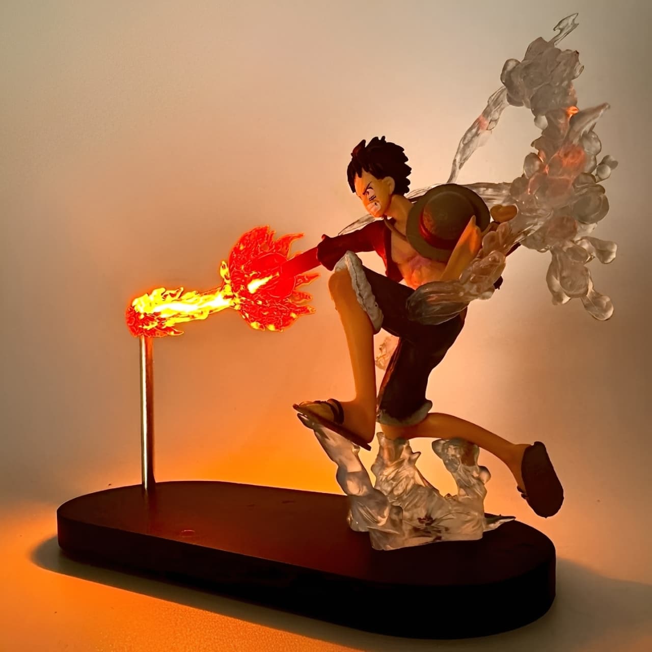 Side view of Luffy Fire Fist figure with LED light-up flame punch
