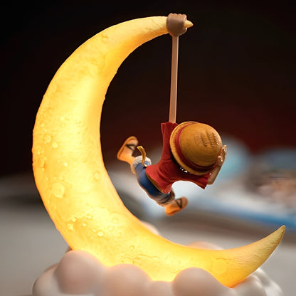 Back view of One Piece Luffy figure hanging on crescent moon LED night lamp.